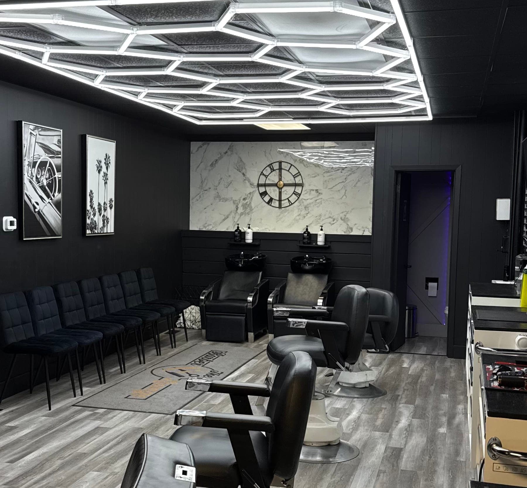 Inside the Fergus shop — hex ceiling lights, the chair line and the waiting bench