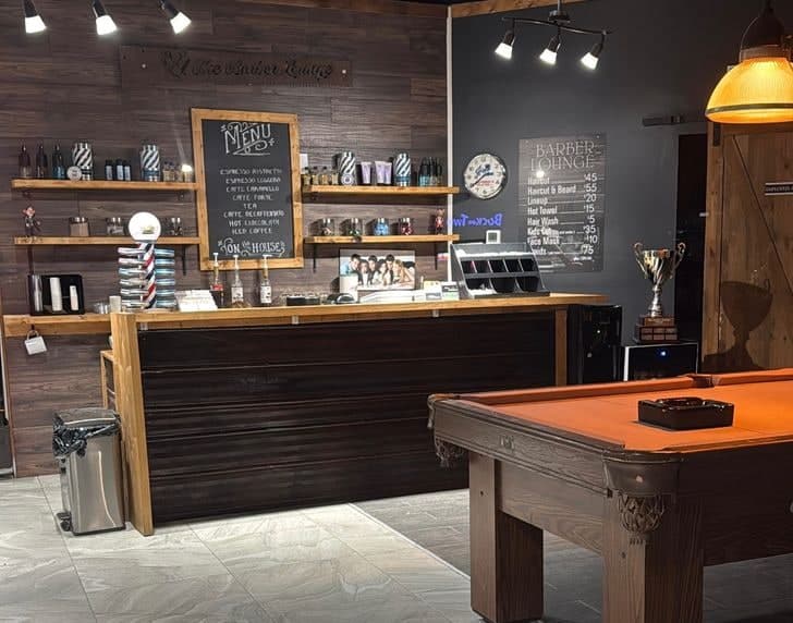 Inside the Victoria Rd shop — the coffee menu, front counter and pool table